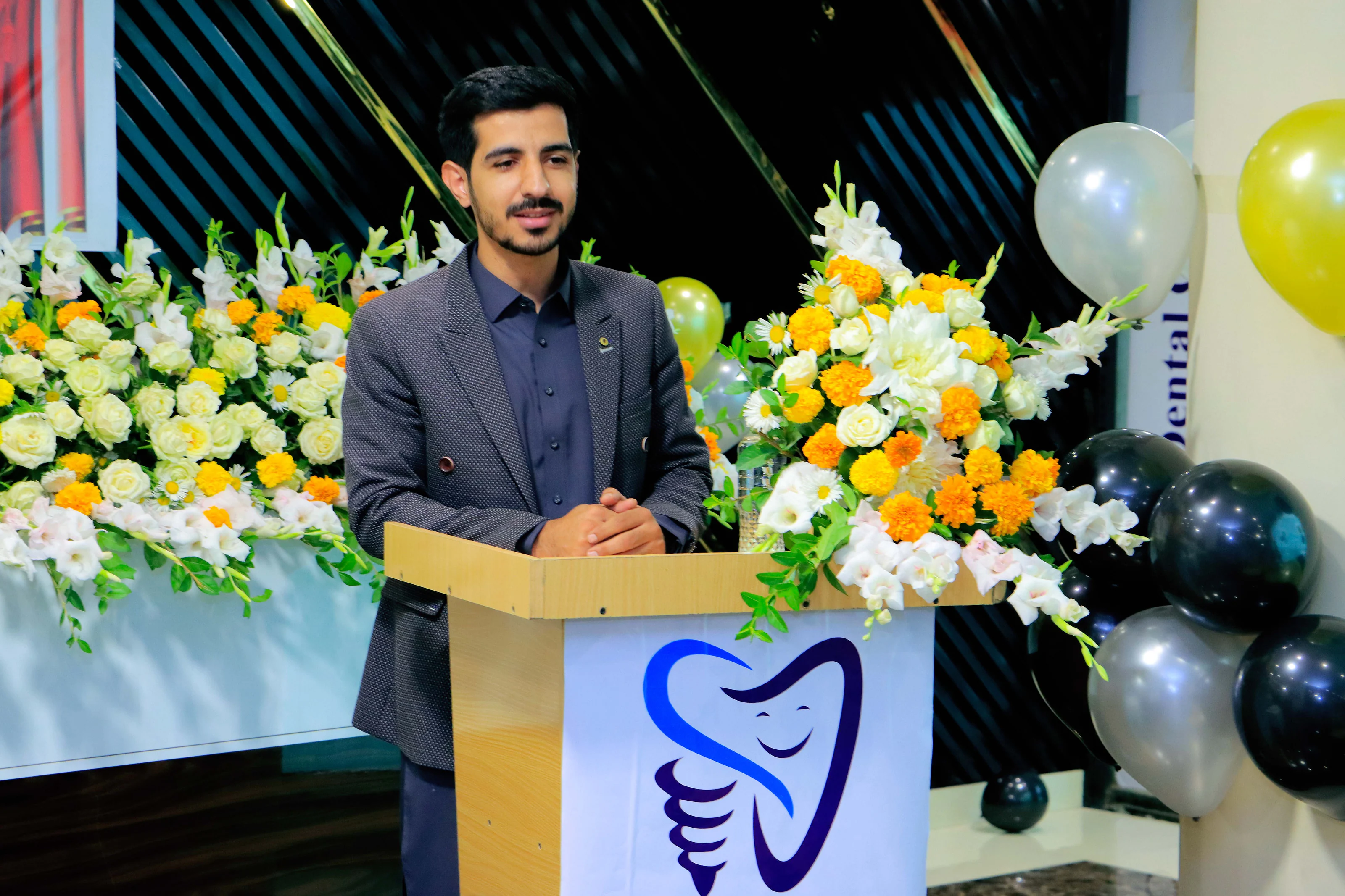 Dr. Arash Kiumars speaking at the City Smile anniversary celebration