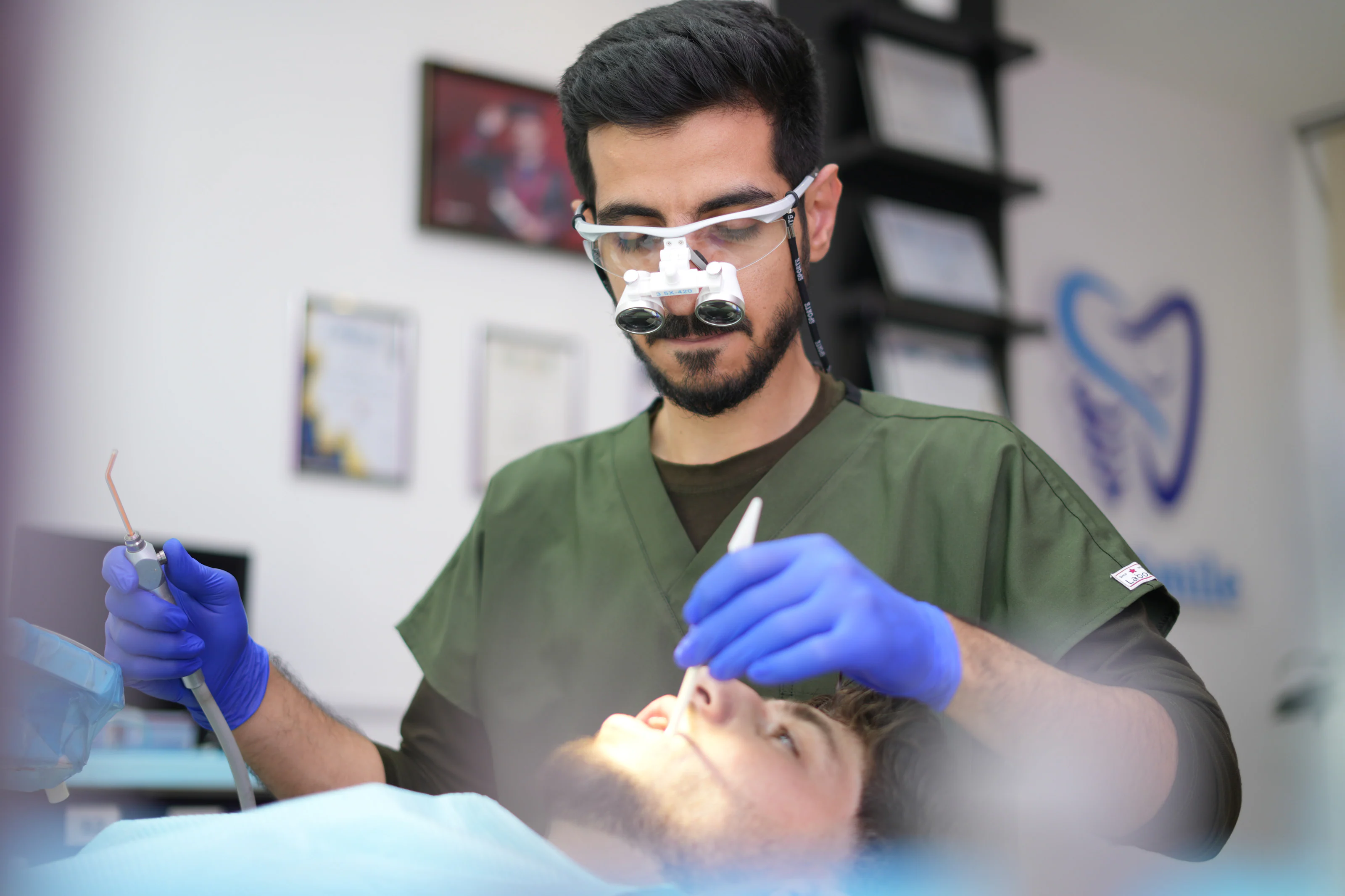 Close-up of Dr. Arash Kiumars treating a patient