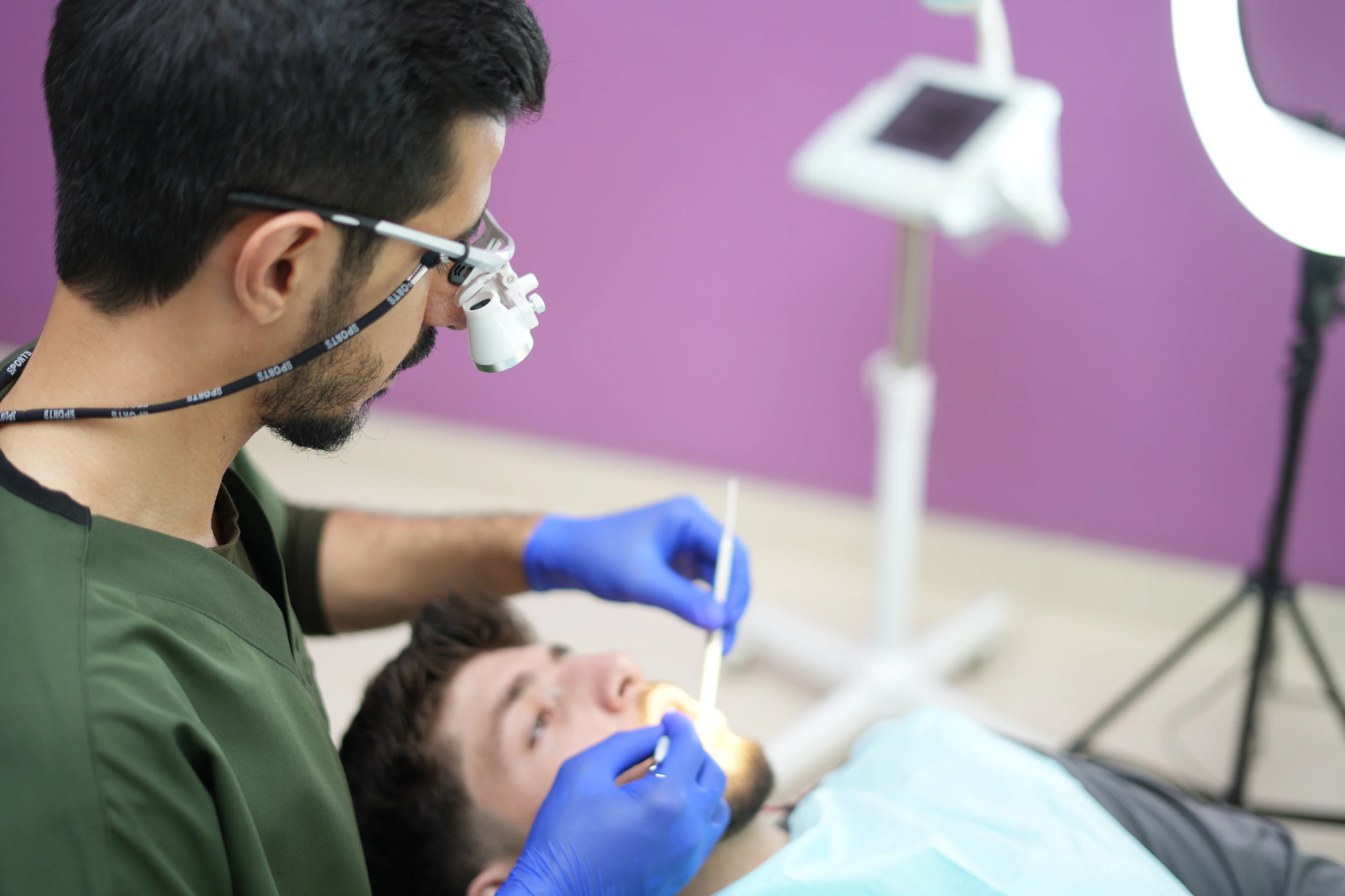 Dr. Arash Kiumars examining a patient in a treatment room