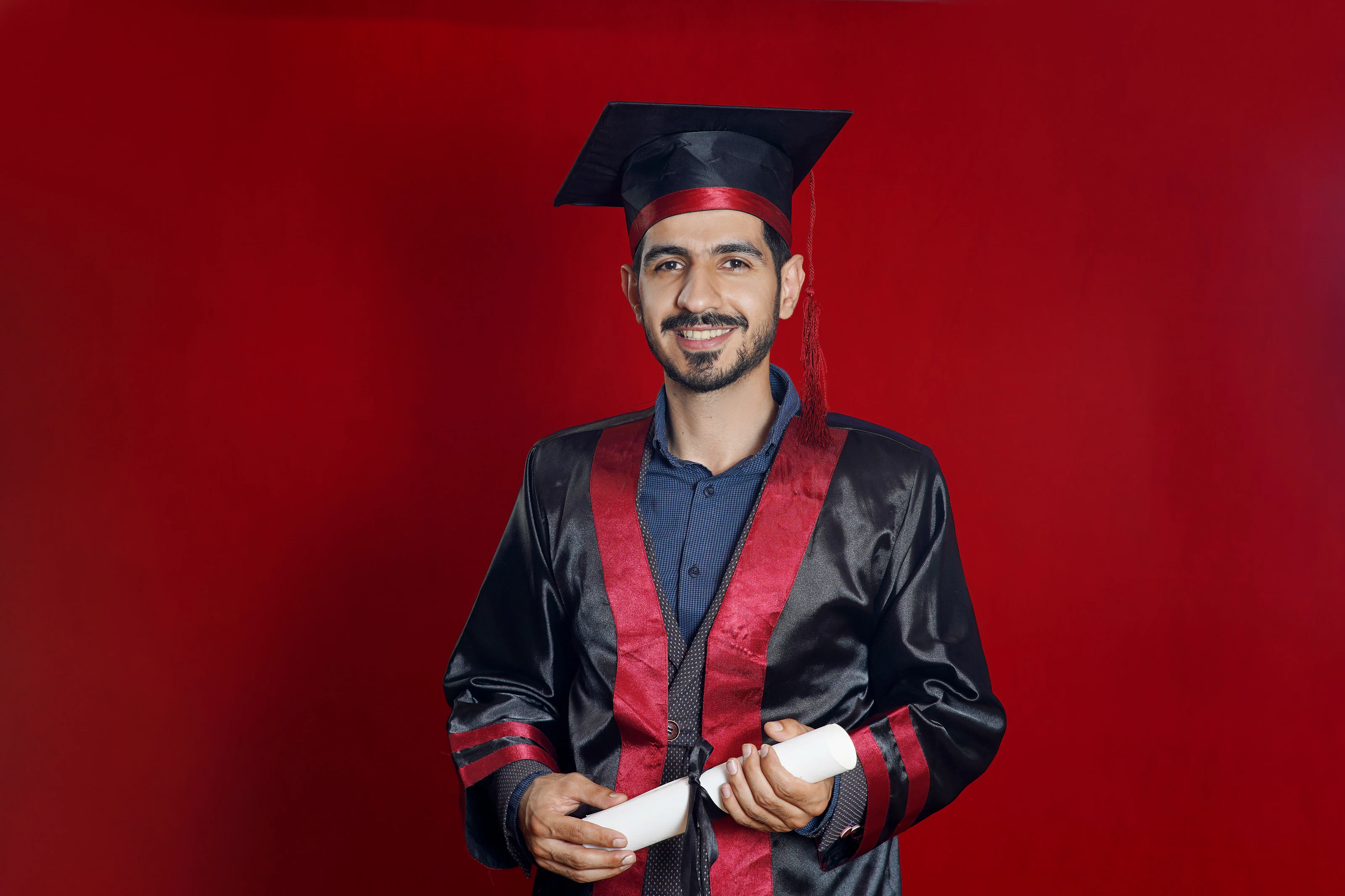 Dr. Arash Kiumars in graduation gown and cap
