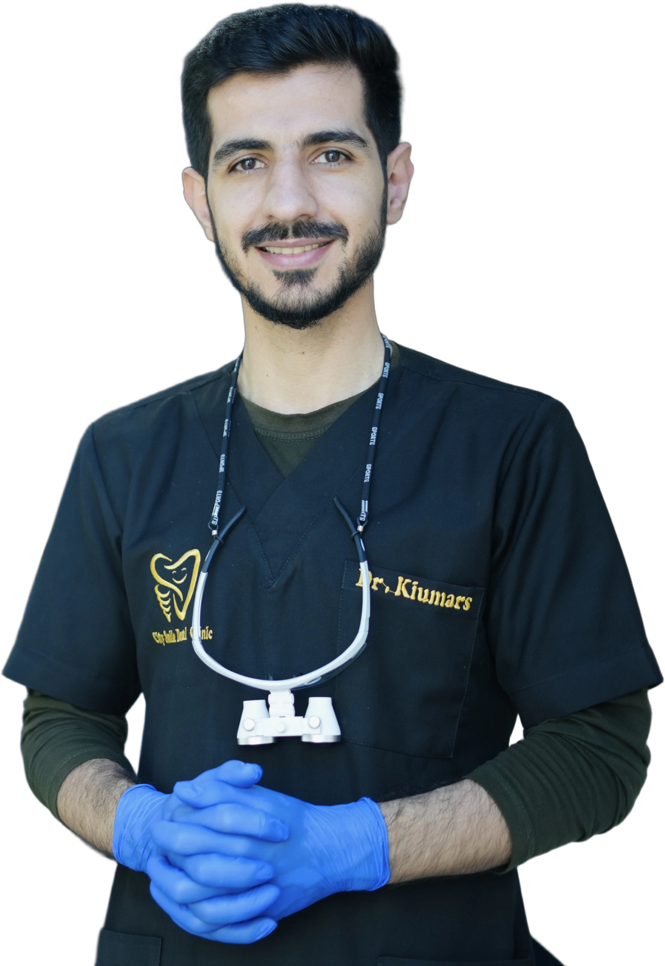 Dr. Arash Kiumars smiling in City Smile scrubs, wearing gloves and dental loupes